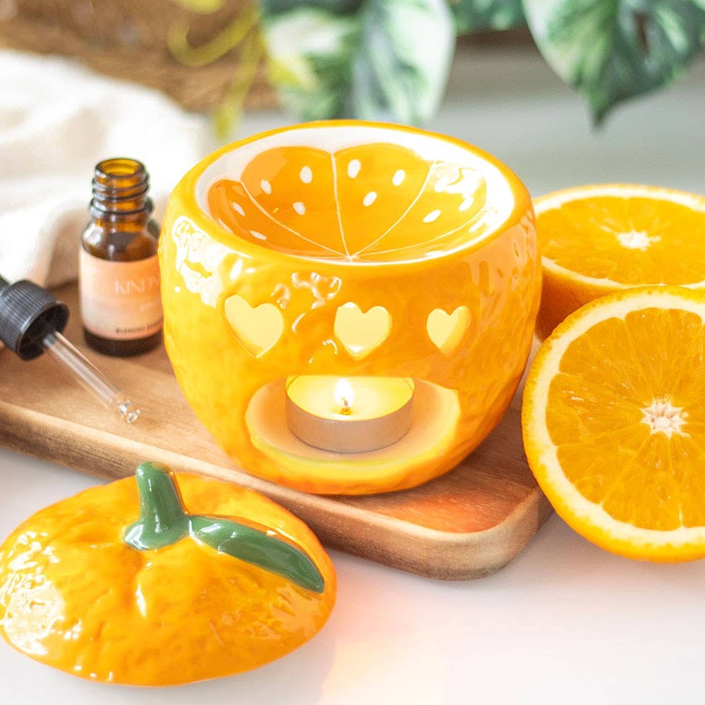 Oil burner shaped like a freshly picked orange