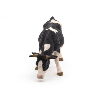 Figurine Vache noire et blanche broutant
