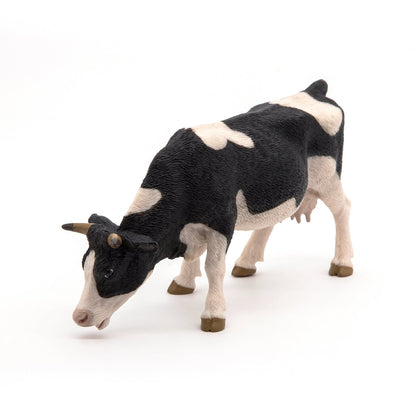 Figurine Vache noire et blanche broutant