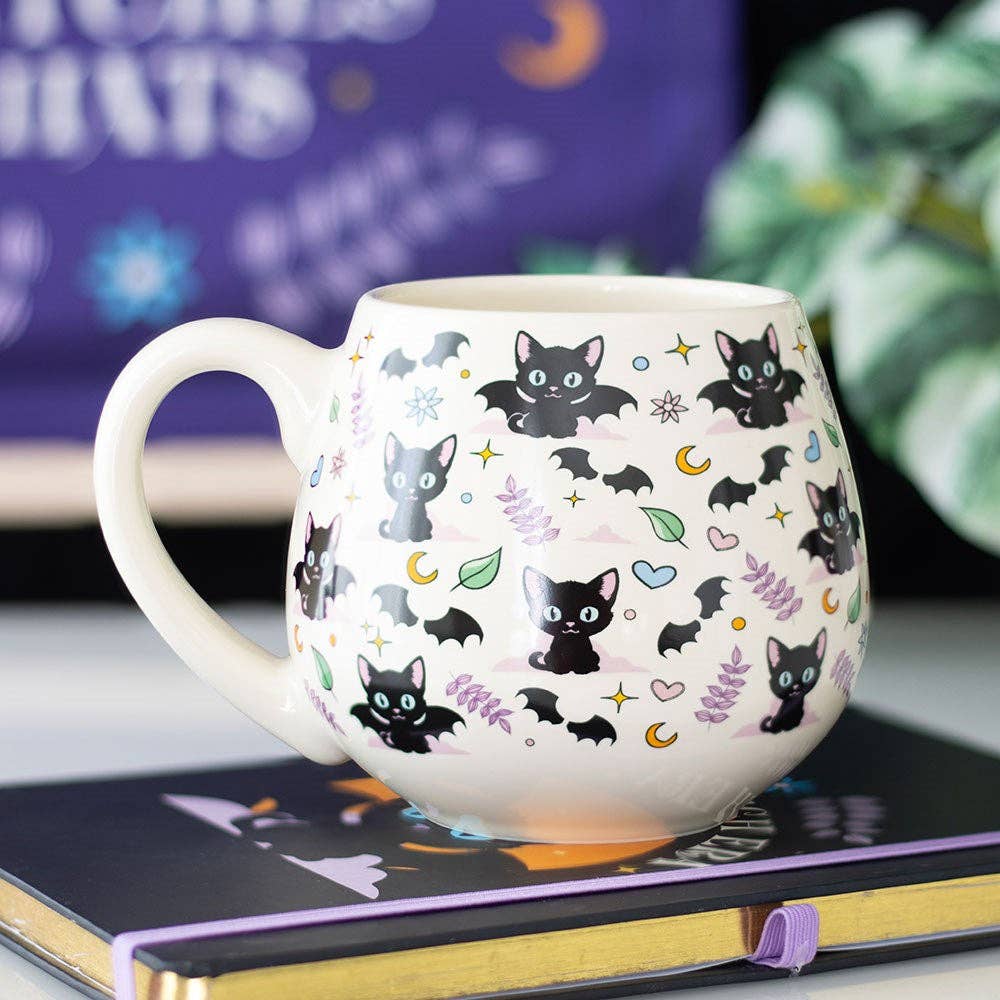 Round ceramic mug with cute and mysterious black cat designs