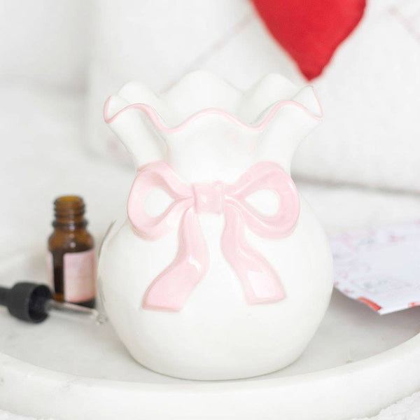 Brûleur d'huile blanc et rose avec nœud