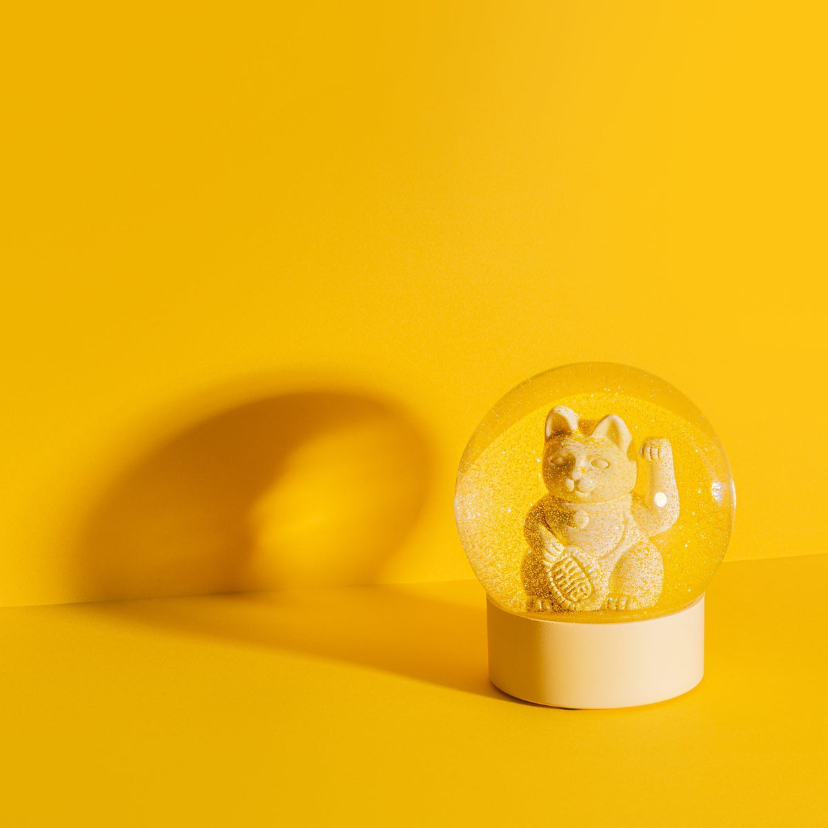 Bola de nieve con forma de gato de la suerte de color amarillo