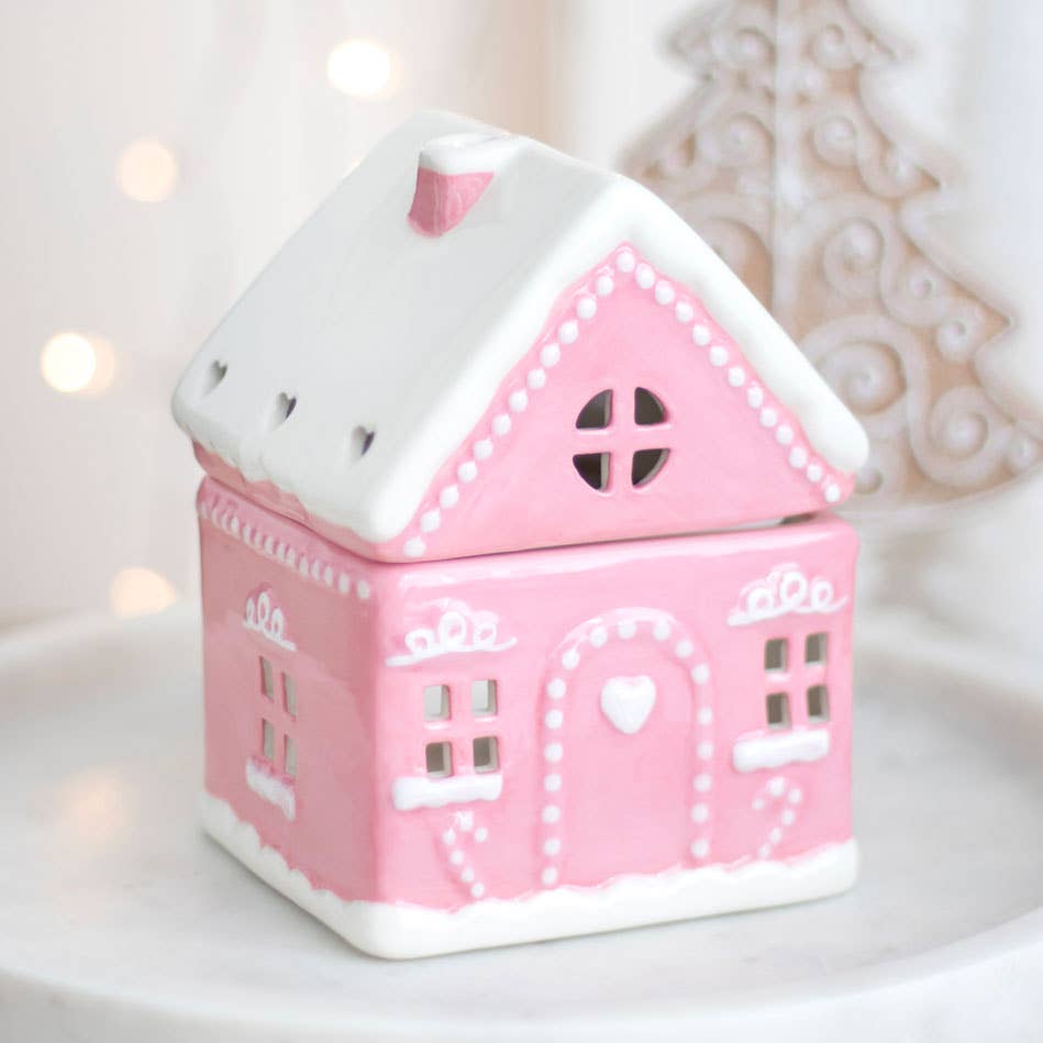 Quemador de aceite navideño con forma de casa de jengibre rosa